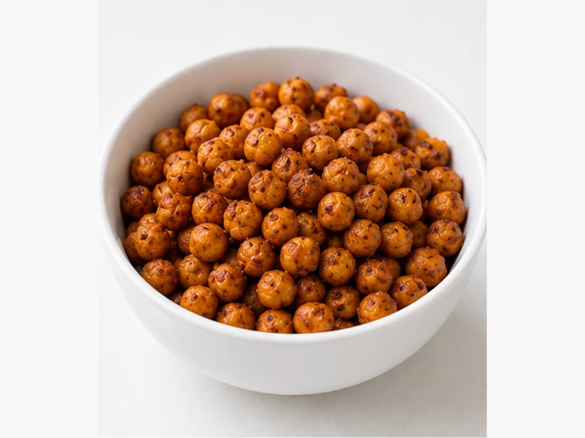 Small bowl of crispy roasted chickpeas dusted with paprika; top-down.